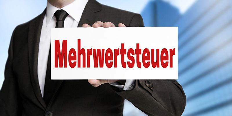 Mehrwertsteuer (in german VAT) sign is held by businessman